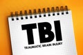 TBI Traumatic Brain Injury - intracranial injury to the brain caused by an external force, acronym text concept on notepad