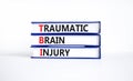 TBI traumatic brain injury symbol. Concept words TBI traumatic brain injury on books on a beautiful white table white background.