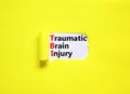 TBI traumatic brain injury symbol. Concept words TBI traumatic brain injury on white paper on a beautiful yellow background. Royalty Free Stock Photo