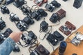 18.05.2022. Tbilisi, Georgia. customer making a choice between old retro cameras at the flea market