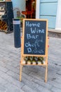 Tbilisi, Georgia, 16 December 2019 -  chalkboard advertising of  cafe and a set of wine bottles on a pedestrian street Royalty Free Stock Photo