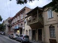 TBILISI, GEORGIA - JULY 7, 2019: View of brick house and cars. Beautiful doors and gates. Prospect of a brick house.