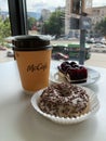 Tbilisi, Georgia - June 18 2022: Hot McDonald`s drink and donut and chocolate cherry pie