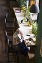 Situation in the cafe, young turkish women drinks coffee and talks on the mobile phone