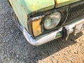 TBILISI, GEORGIA - - MAY 17, 2018: An old iron rusty car with an old headlight from the front. Close up shot Royalty Free Stock Photo