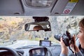 Tbilisi, Georgia - October 19, 2019: Cable of car, steering wheel, dashboard, Navigator, mirror and girl as passanger with camera