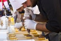 Confectioner chef cooking dessert scene, chef decorates cake and working in the street of Tbilisi on the city festival