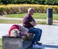 Tired elderly tourists rest on a bench in Rike Park in old part of Tbilisi city in Georgia