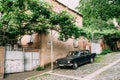 Tbilisi Georgia. Parked Black Volga GAZ Retro Rarity Car Near Private Residential House Under Vine Canopy On Cobbled Royalty Free Stock Photo