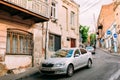 Tbilisi Georgia. Parked Silvery Skoda Octavia Car Near Shabby Building On Narrow Uphill Street