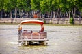 Tbilisi Georgia - Pontoon boat with female passengers in headscarves on Mtkvari - Kura River with retaining wall and