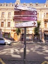 Tbilisi, Georgia - 07 23 2022: A post with street directions signs with arrows and names of sightseeing places in front