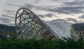 Tbilisi, Georgia-SEPTEMBER 25, 2016: New glass bridge across the river Kura Metekhi. Symbol of peace