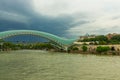 TBILISI, GEORGIA: View over the modern glass Peace bridge to the President Palace before the rain. Royalty Free Stock Photo