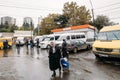 Tbilisi, Georgia. Woman Walks Near Urban Taxis Minibuses Are On