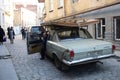 In Tbilisi, an old man is coming down from an old car