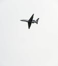 Small jet overhead on overcast day Royalty Free Stock Photo