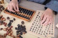 TCM doctors use traditional Chinese abacus to calculate the amount of medicine on prescription Royalty Free Stock Photo