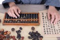 TCM doctors use traditional Chinese abacus to calculate the amount of medicine on prescription Royalty Free Stock Photo