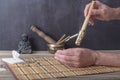 TCM Traditional Chinese Medicine, hand applying moxa stick.