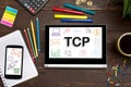 TCP Transmission Control Protocol the inscription on the touch-screen tablet on the table of a businessman