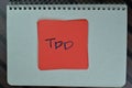 TDD write on sticky notes isolated on Wooden Table Royalty Free Stock Photo