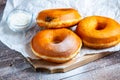 TDelicious donuts with powdered sugar on wooden table Royalty Free Stock Photo