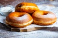 TDelicious donuts with powdered sugar on wooden table Royalty Free Stock Photo