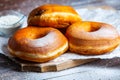 TDelicious donuts with powdered sugar on wooden table Royalty Free Stock Photo