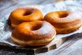 TDelicious donuts with powdered sugar on wooden table Royalty Free Stock Photo