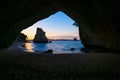 Te Hoho Rock standing in sun framed by the natural arch of Cathedral Cove on Coromandel Peninsula New Zealand Royalty Free Stock Photo