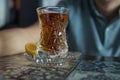 Tea in Azerbaijani traditional armudu pear-shaped glass . Azerbaijan black tea .white sugar cubes . Black turkish tea in pear Royalty Free Stock Photo
