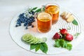 Tea background . Tea in transparent mugs with lemon, lemons, limes, mint, cherry blossoms. Stylish, colorful background. Food ind Royalty Free Stock Photo