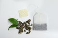 Tea bag and dried leaves on white background Royalty Free Stock Photo