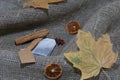 Tea bag, dried maple leaves on a rough linen cloth. Nearby are cinnamon, dried orange slices and anise. Autumn still life Royalty Free Stock Photo