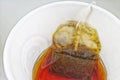 Tea bag in paper cup and hot water Royalty Free Stock Photo