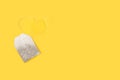 A tea bag with a yellow label on a yellow background Royalty Free Stock Photo