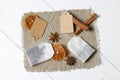 Tea bags, anise, cinnamon sticks and slices of dried tangerines. Lying on a piece of linen. Against the background of white