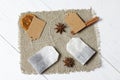 Tea bags, anise, cinnamon sticks and slices of dried tangerines. Lying on a piece of linen. Against the background of white