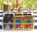 Tea Bags in Clear Acrylic Tea Bag Holder with Silverware Pot Set Royalty Free Stock Photo