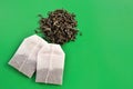 Tea bags and loose tea on a green background Royalty Free Stock Photo