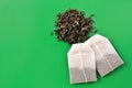 Tea bags and loose tea on a green background Royalty Free Stock Photo