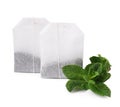 Tea bags and mint on white background Royalty Free Stock Photo