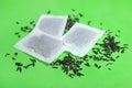 Tea bags with scattered dry leaves Royalty Free Stock Photo