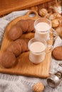 Breakfast for two. Tea with milk and oatmeal cookies on a wooden background.Tea and biscuits on the kitchen board.