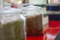 Tea blends in glass jars on the counter of the cafe. Bright colors of tea