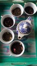 Tea blends and teapot on a wooden green tray