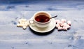 Tea break concept. Drink and sweets prepared as dessert. Mug filled with black brewed tea, spoon and heap of marshmallow Royalty Free Stock Photo