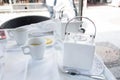 tea break with a white tea set at a table in a cafe in the city