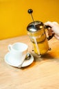 Tea brewer. cup of hot tea. women`s hands pour tea.